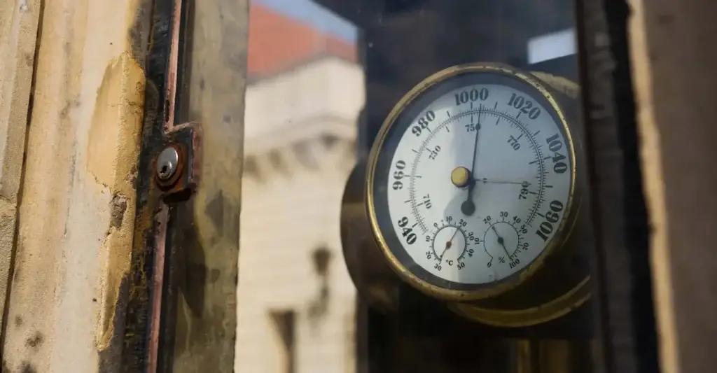 Antique barometer behind glass before causing a mercury spill.
